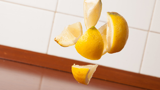 Sliced lemon thrown into the air.