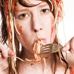 girl stuffing face with spaghetti