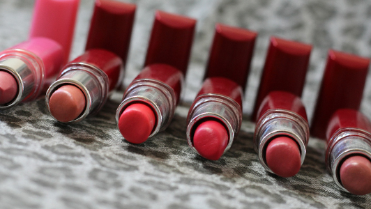 Different shades of lipstick lined up.