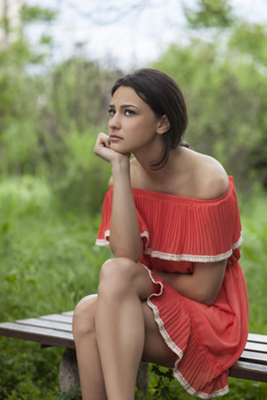 women sitting on bench outside thinking