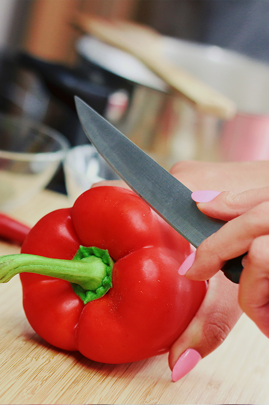 Red paprika being chopped.