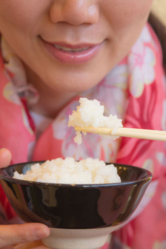 woman eating rice with chopsticks