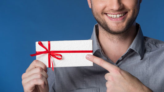 smiling man pointing at gift card