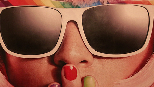 Girl with retro sunglasses and nails of different colour