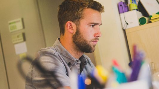 Guy working at his desk.