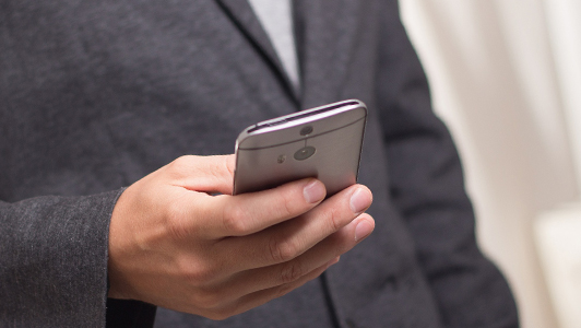 A man holding an iPhone.