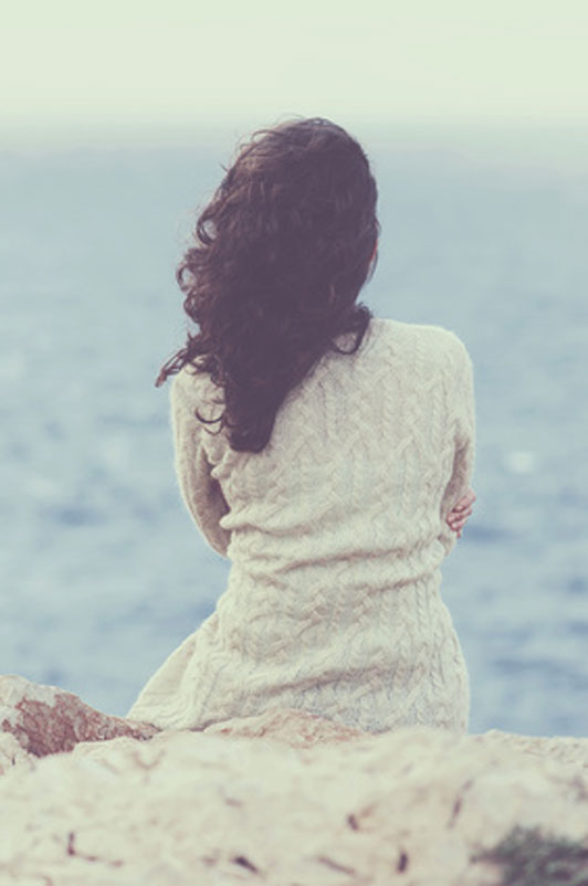 worried girl looking over sea