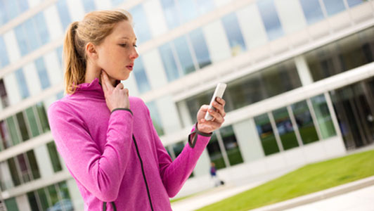 woman looking at phone checking heart rate