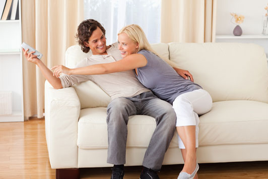 couple fighting over remote control