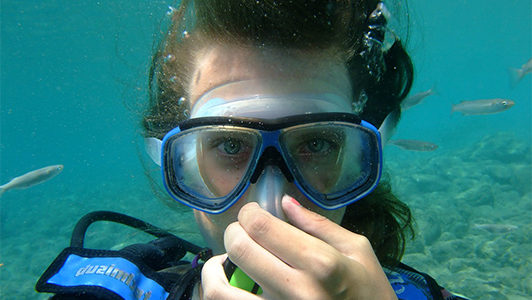 Girl carrying a mask under water