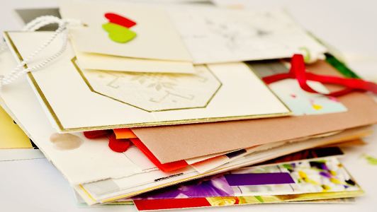 A stack of colorful letters and cards