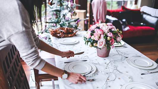 Girl setting a table.