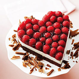 A heart shaped cake with raspberries 