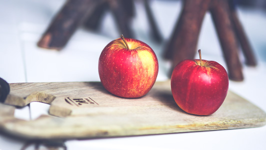 Two apples on a cutting board