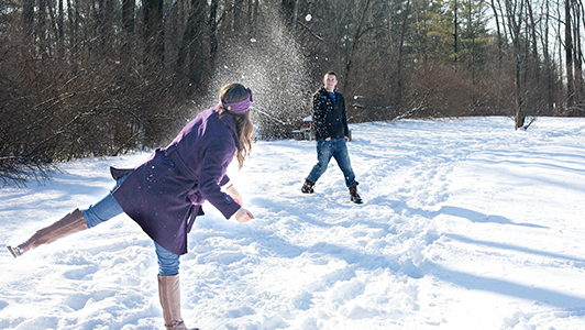 Couple playing in the snow.