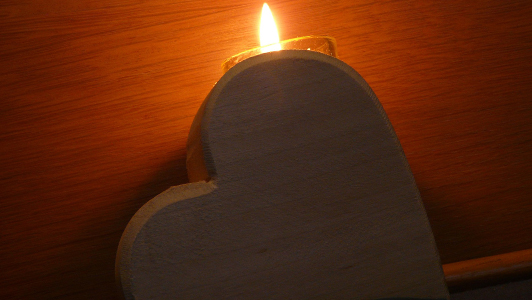 wooden heart holding a candle