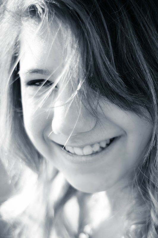 A teen girl smiling.
