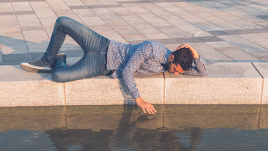 man looking at relection of self in water