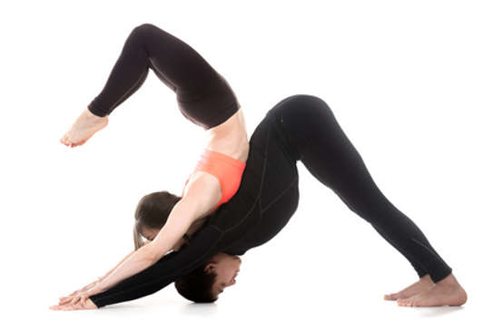 couple in scorpion and downward facing dog posture