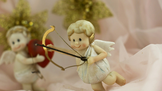 Little Cupid holding bow and arrow.