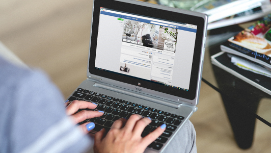 Girl typing on a netbook.