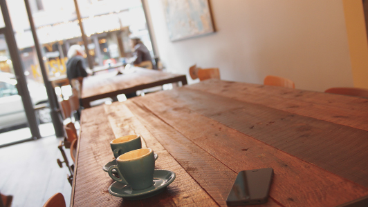 Two coffee cups on a table.