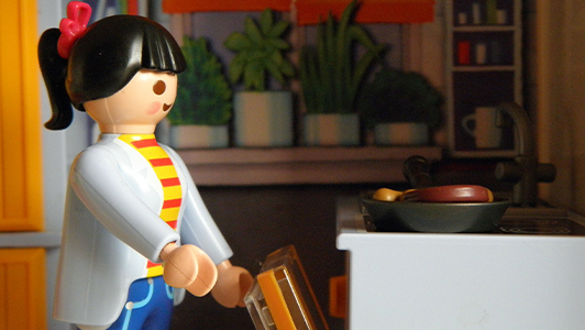 A lego doll cooking.