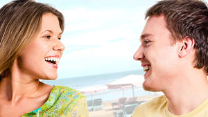 Guy and a girl laughing and talking outdoors