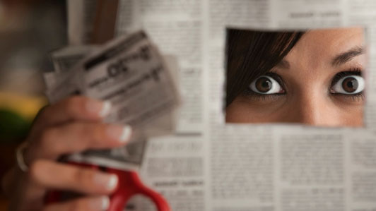 afraid girl hiding behind newspaper