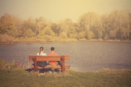 couple on bench near lake