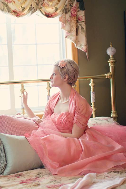 woman in dress on bed inside house