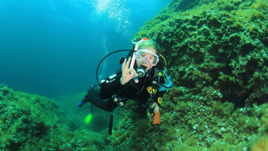 scuba woman giving okay sign