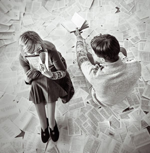 two people sitting together over newspaper