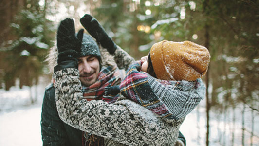 young couple having fun with snow