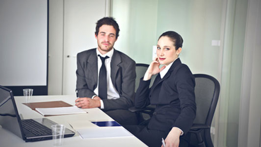 two people sitting at desk