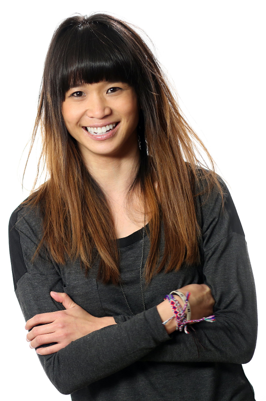 Girl with ombre hair holding her arms folded.