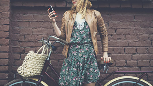 woman with bike texting