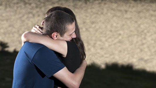 two people hugging goodbye