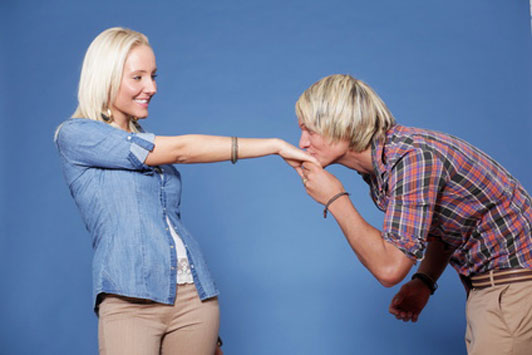 man kissing hand off woman