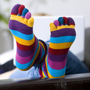 toe socks with woman in background on laptop