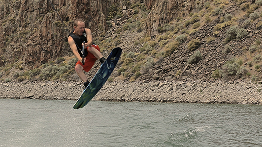 Guy on a wakeboard caught in the air.