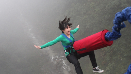 Girl in green shirt bungee jumping.