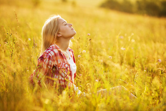 girl in open field taking deep breaths