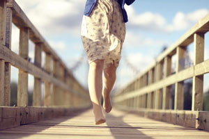running barefoot over bridge