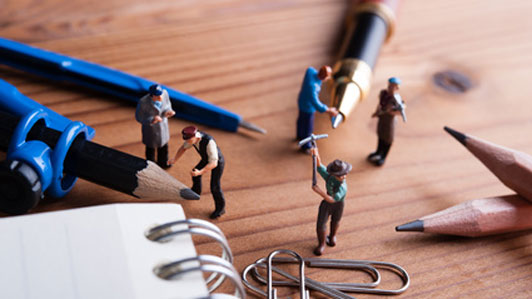 mini men at work measuring stationeries