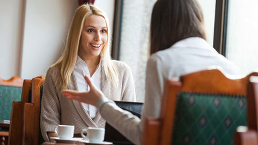 two women in cafe talking