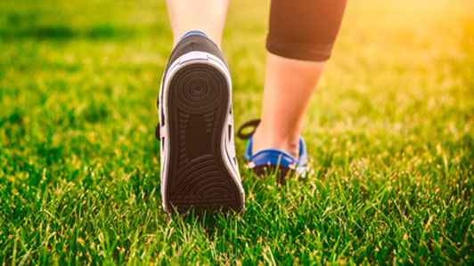 exercise woman stepping through green grass