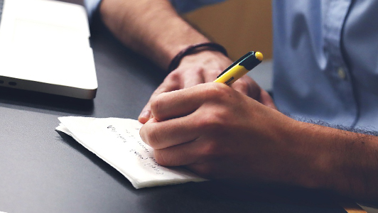 Guy writing on a pad