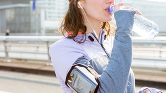 exercise girl drinking from a water bottle