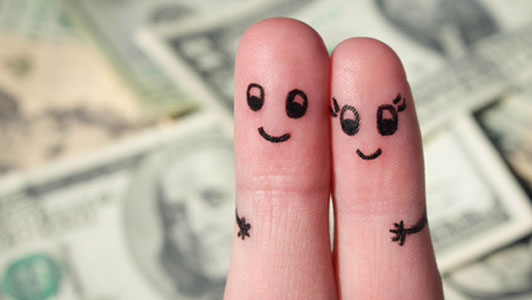 happy finger couple over money